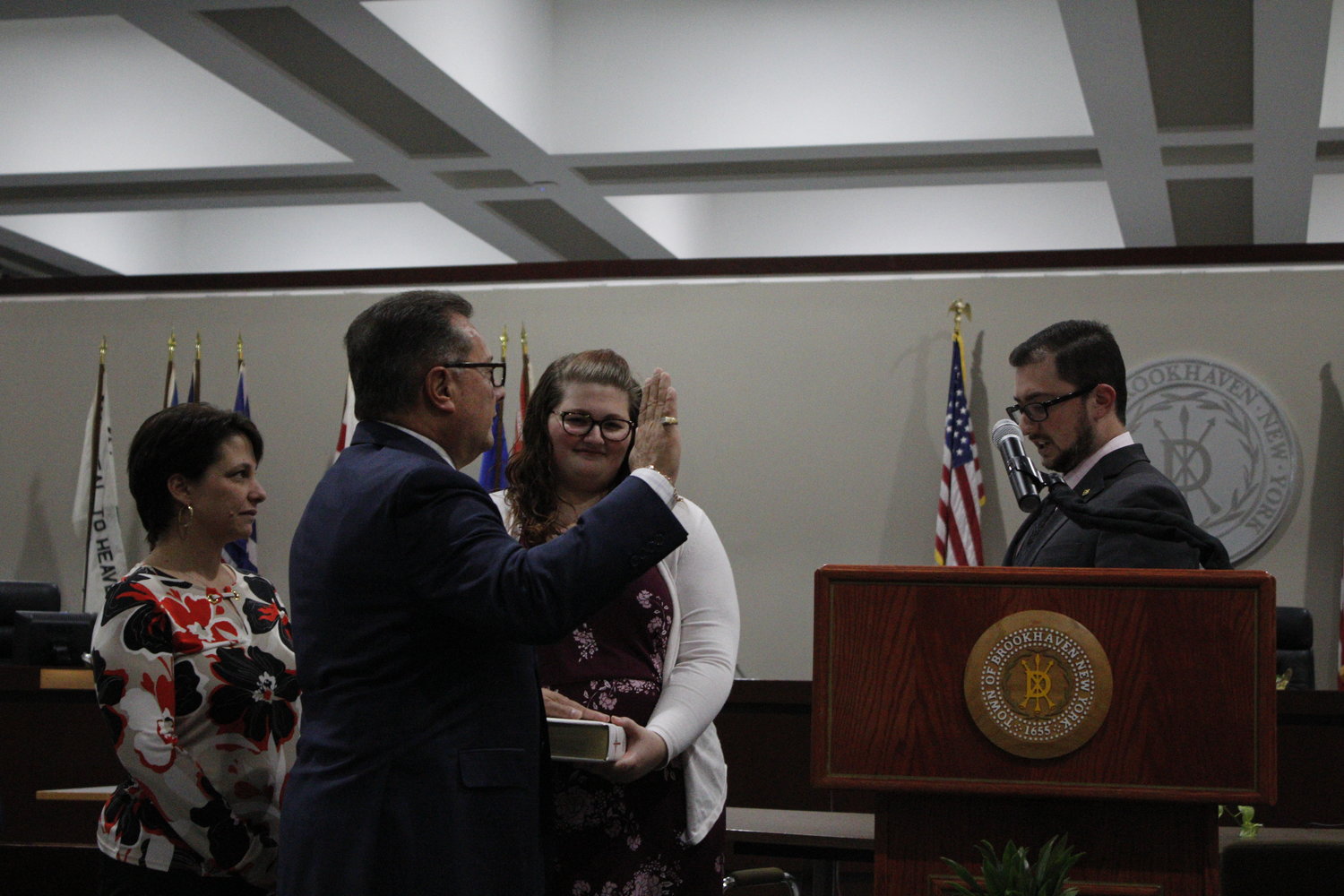 Councilman Mike Loguercio is sworn in by his son, Devin Michael Loguercio.