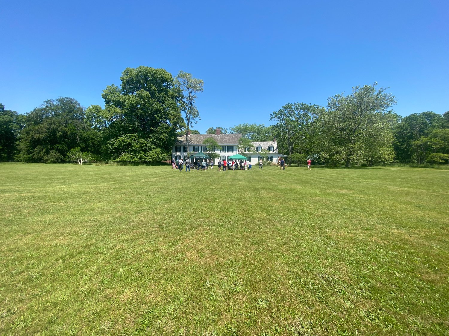 The view of the Tri-Hamlet Day festivities and the William Floyd Manor from the “pightle” (an old English word for yard enclosure) that sits in front of the Manor.