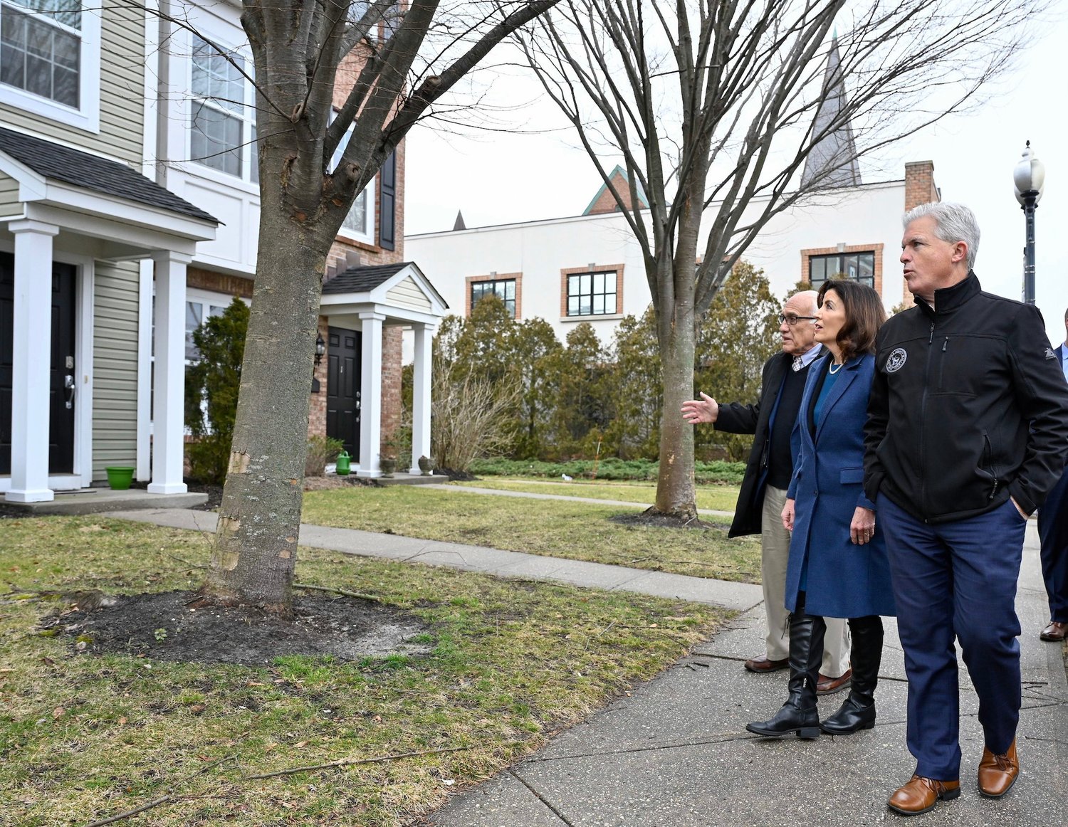 Gov. Kathy Hochul met with Patchogue Village mayor
Paul Pontieri and Suffolk County executive Steve Bellone
last week in Patchogue. In this photo, they are looking at
one of the many housing developments in the village.